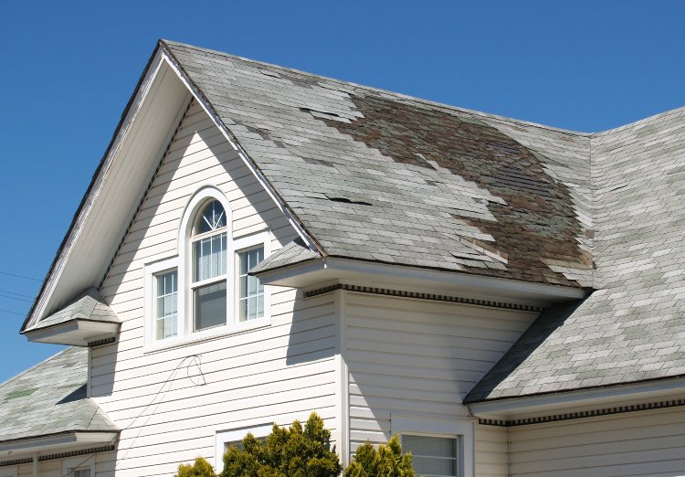 Damaged roof with missing shingles